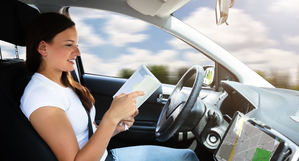 Woman Looking At Diary While Sitting In Car