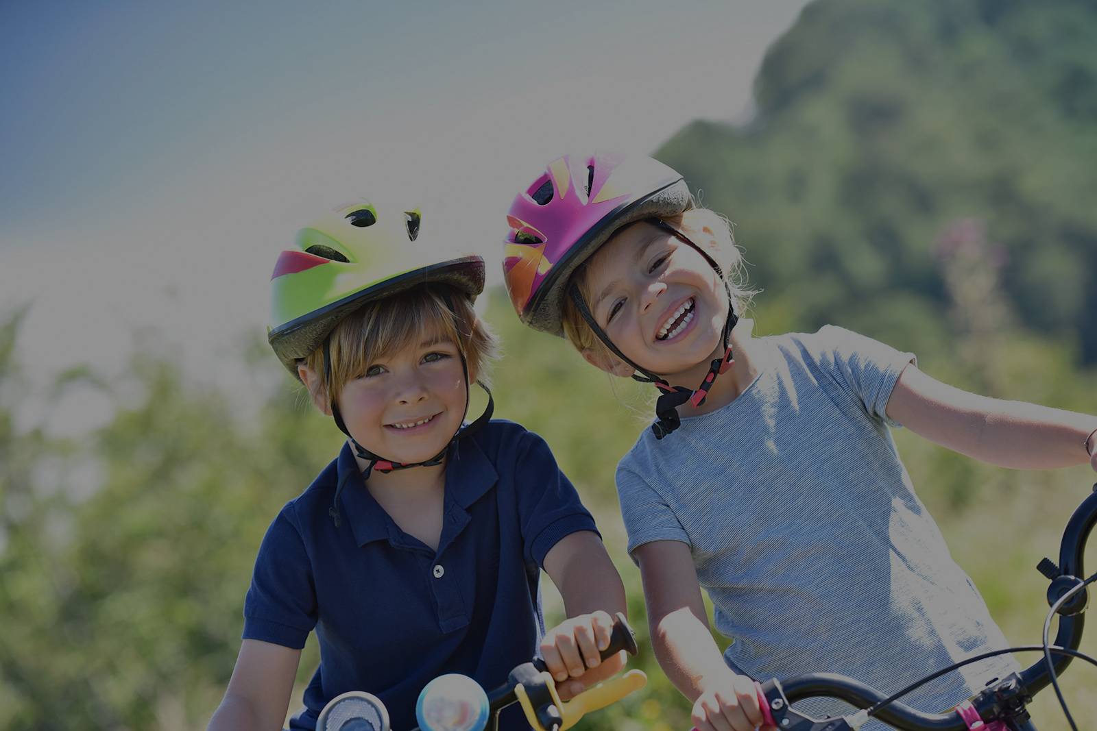 A boy and a girl wearing bike helmets in a bicycle